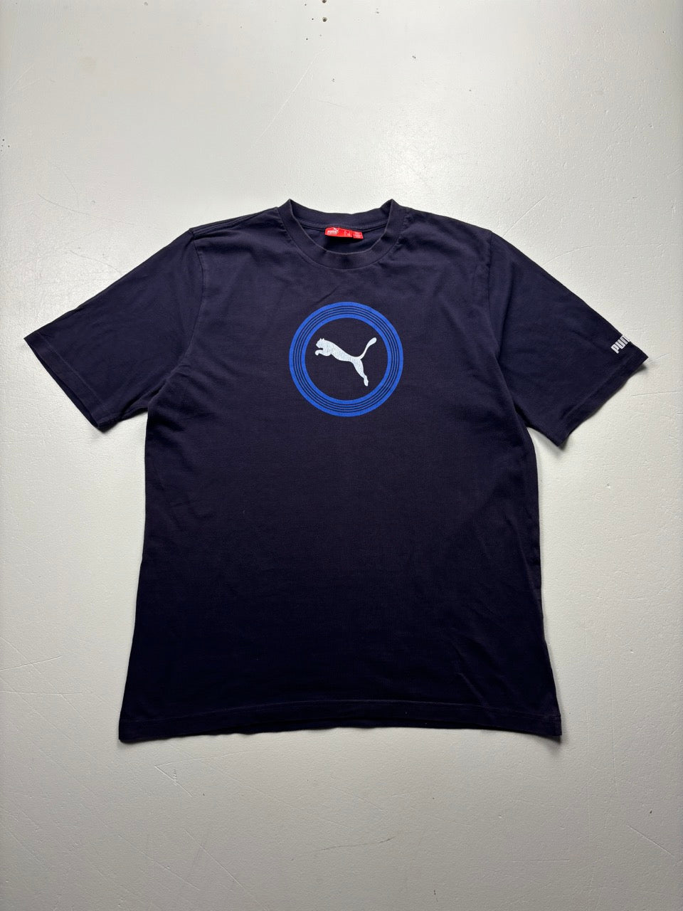 An image of a Puma Navy Graphic Tshirt in size L.